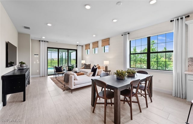 dining room featuring plenty of natural light and light hardwood / wood-style flooring