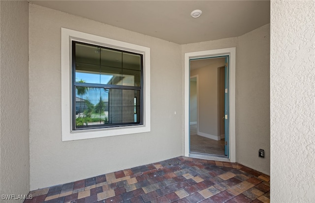 doorway to property featuring a patio area