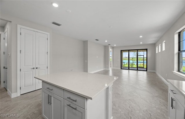 kitchen with light stone countertops and a kitchen island