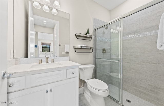 bathroom with vanity, toilet, and an enclosed shower