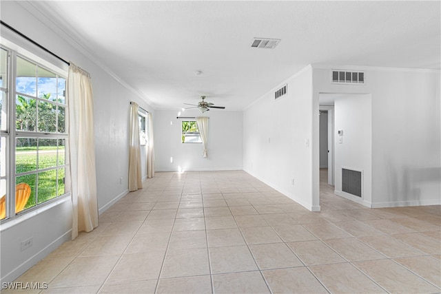 empty room featuring ornamental molding, plenty of natural light, and ceiling fan