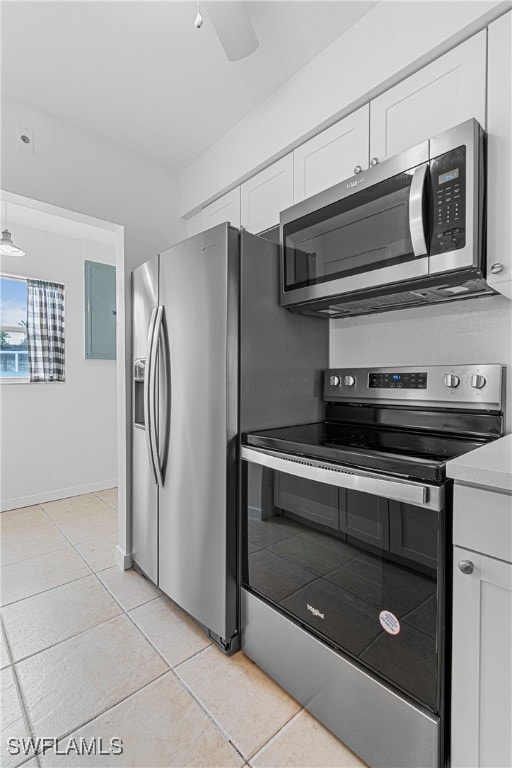 kitchen featuring white cabinetry, stainless steel appliances, and light tile patterned flooring