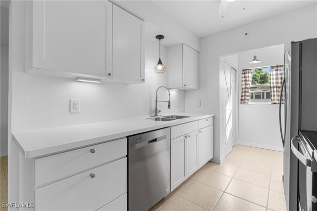 kitchen featuring pendant lighting, white cabinets, sink, and stainless steel appliances