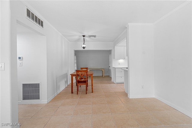 tiled dining space featuring ornamental molding