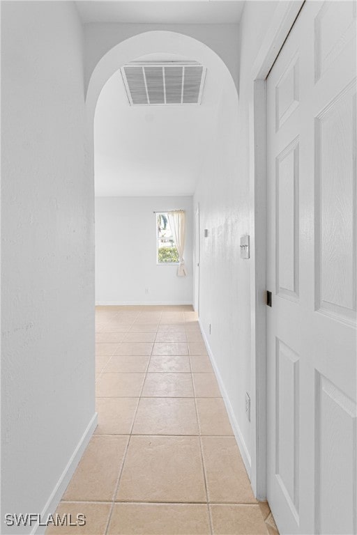 hall featuring light tile patterned flooring