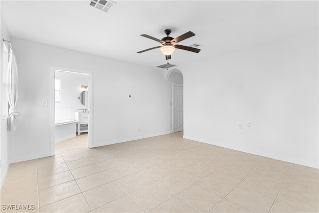 spare room featuring ceiling fan and light tile patterned floors