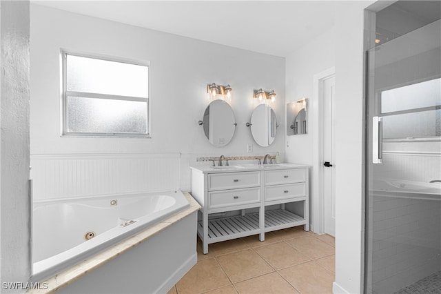 bathroom featuring plus walk in shower, vanity, and tile patterned floors