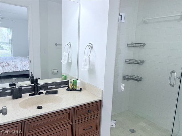 bathroom featuring vanity, ceiling fan, and a shower with shower door