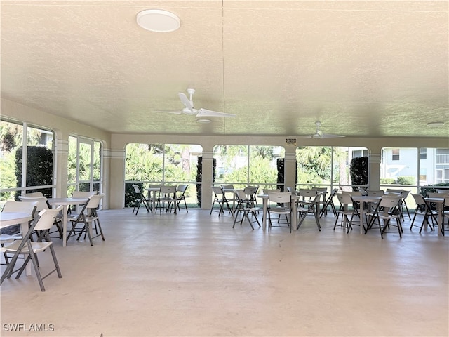 exterior space with concrete floors, ceiling fan, and a textured ceiling