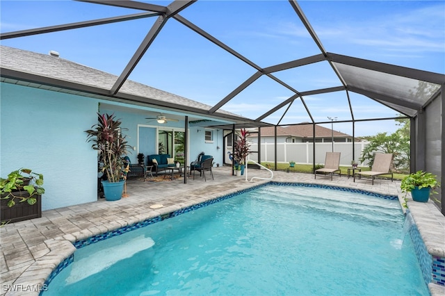 view of pool with a lanai, ceiling fan, pool water feature, and a patio area