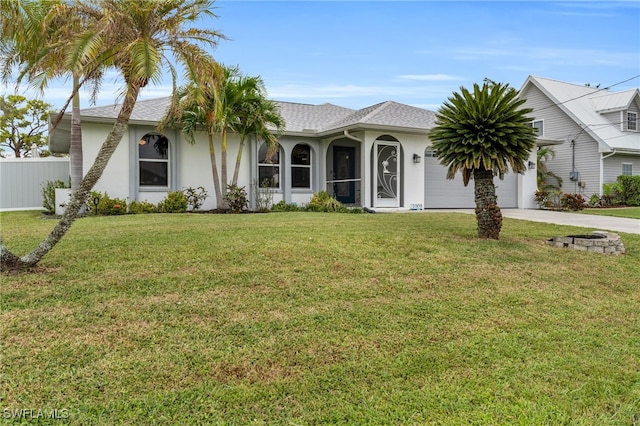 view of front of property featuring a front lawn and a garage