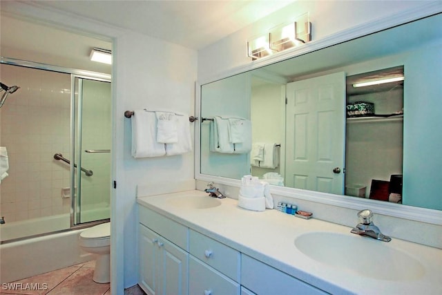 full bathroom with tile patterned flooring, vanity, toilet, and shower / bath combination with glass door