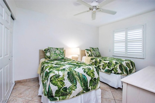 tiled bedroom with a closet and ceiling fan