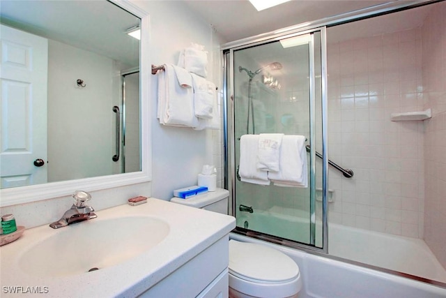 full bathroom featuring combined bath / shower with glass door, vanity, and toilet