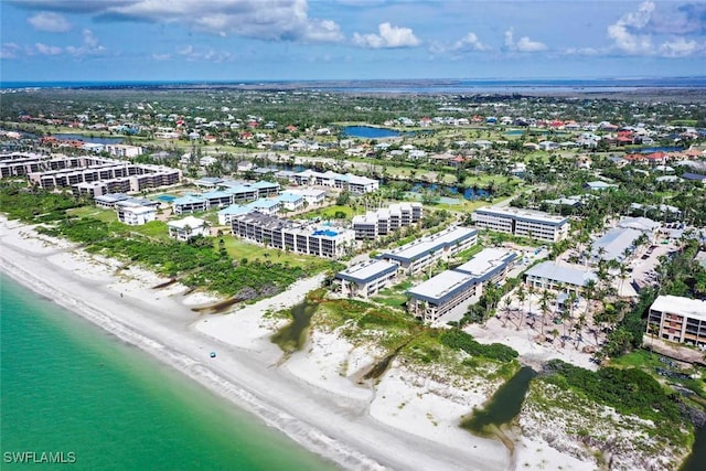 drone / aerial view with a water view and a beach view