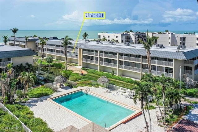 view of pool with a water view and a patio area