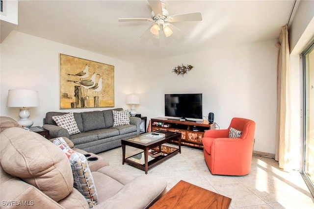 tiled living room with ceiling fan