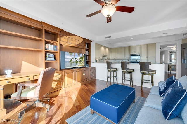 living room with ceiling fan and dark hardwood / wood-style floors