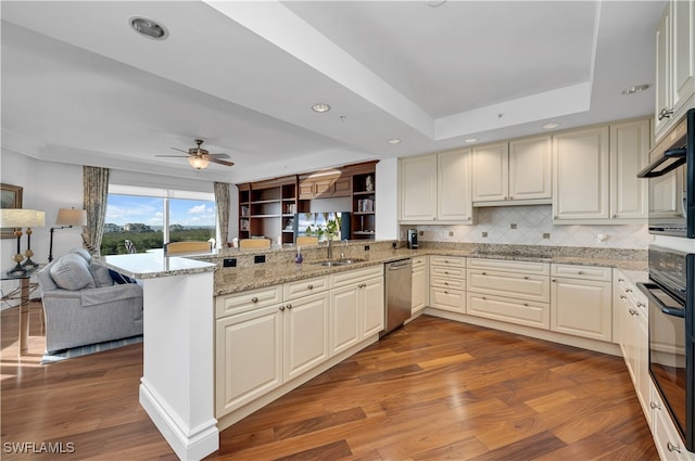 kitchen with sink, kitchen peninsula, hardwood / wood-style floors, oven, and dishwasher