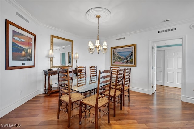 dining area featuring an inviting chandelier, wood-type flooring, and crown molding