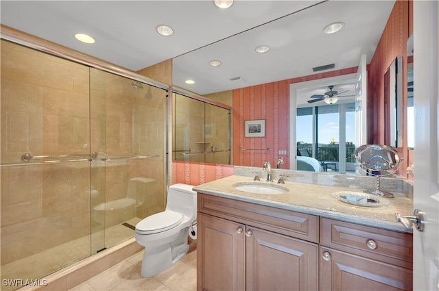 bathroom featuring toilet, tile patterned flooring, vanity, ceiling fan, and a shower with shower door