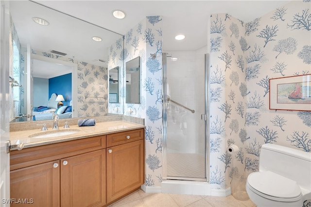 bathroom featuring vanity, a shower with shower door, tile patterned flooring, and toilet