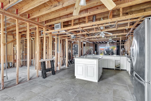 interior space with ceiling fan