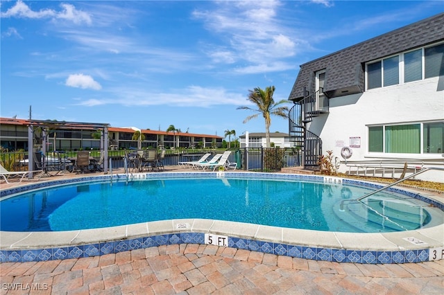 view of swimming pool with a patio area