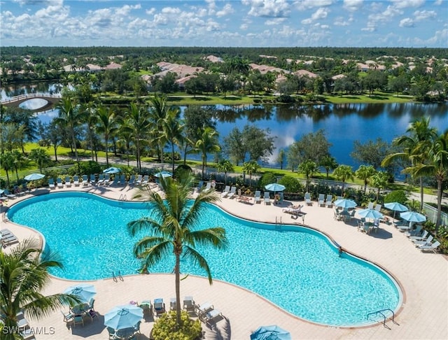 view of swimming pool with a water view and a patio area