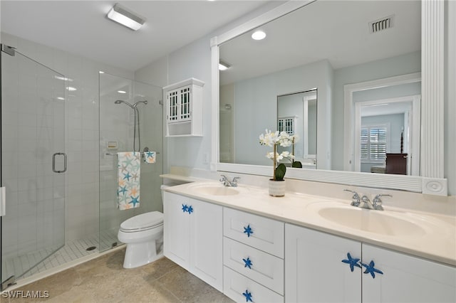 bathroom featuring a shower with shower door, toilet, and vanity