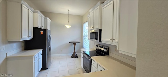 kitchen with pendant lighting, appliances with stainless steel finishes, light tile patterned floors, and white cabinets