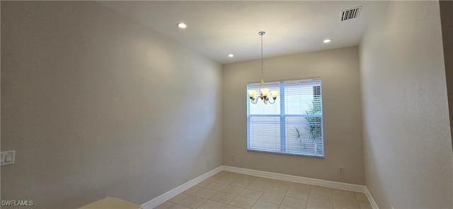 empty room featuring a notable chandelier