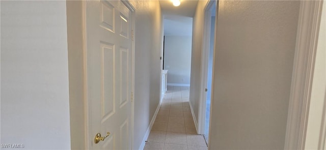 hall featuring light tile patterned floors