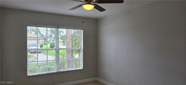 empty room featuring ceiling fan and a healthy amount of sunlight