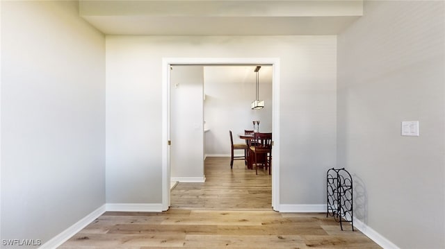 corridor with hardwood / wood-style floors