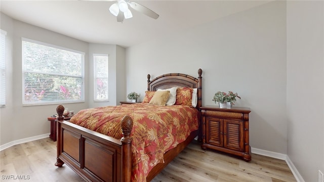 bedroom with ceiling fan and light wood-type flooring