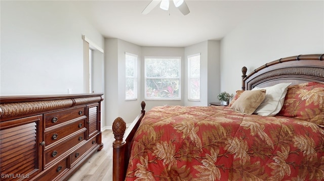 bedroom with light hardwood / wood-style floors and ceiling fan