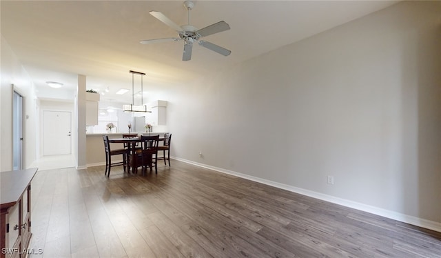 dining area featuring hardwood / wood-style flooring and ceiling fan