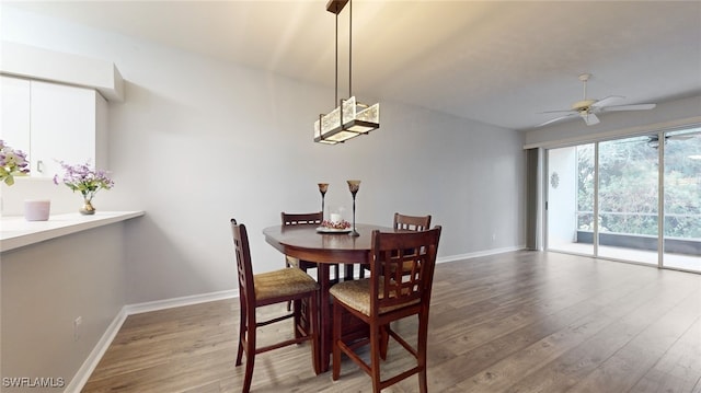 dining space with wood-type flooring and ceiling fan