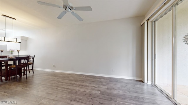 dining area featuring wood-type flooring and ceiling fan