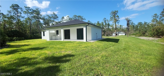 rear view of house featuring a yard