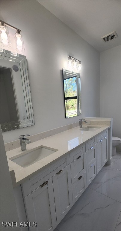 bathroom featuring vanity and toilet