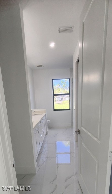 bathroom featuring vanity and toilet