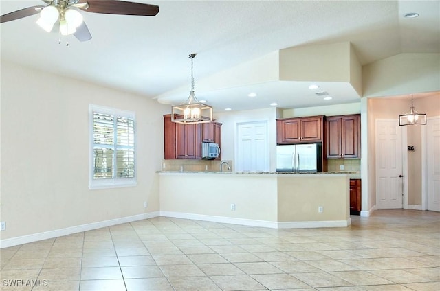 kitchen featuring hanging light fixtures, stainless steel appliances, tasteful backsplash, vaulted ceiling, and kitchen peninsula