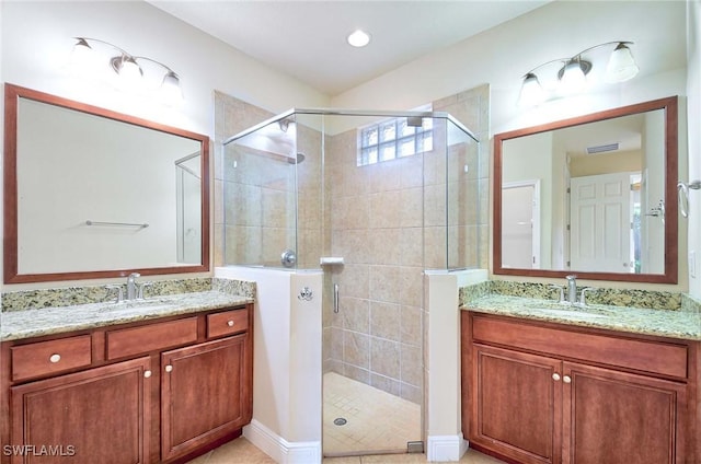 bathroom with an enclosed shower and vanity