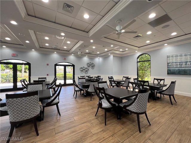 dining area featuring crown molding, light hardwood / wood-style floors, and french doors