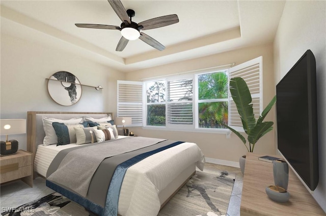 bedroom with a raised ceiling and ceiling fan