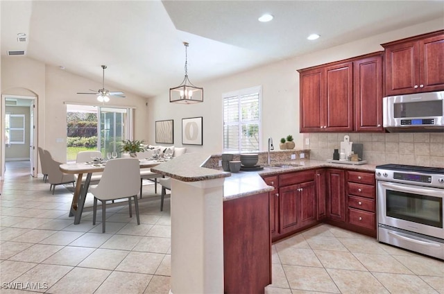 kitchen featuring a peninsula, appliances with stainless steel finishes, light tile patterned floors, and plenty of natural light