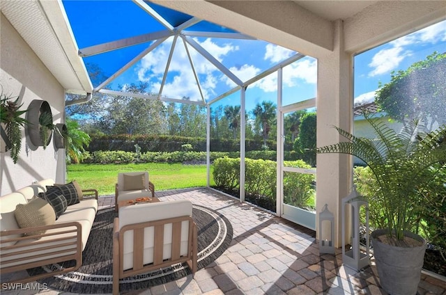 view of patio / terrace with an outdoor living space and glass enclosure