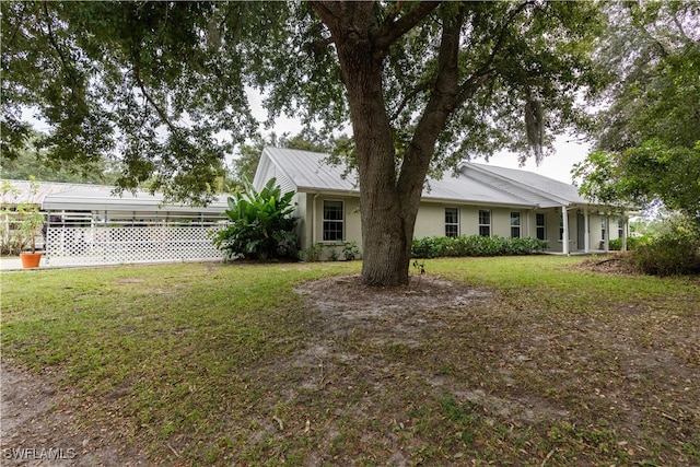 exterior space with a lawn and a carport